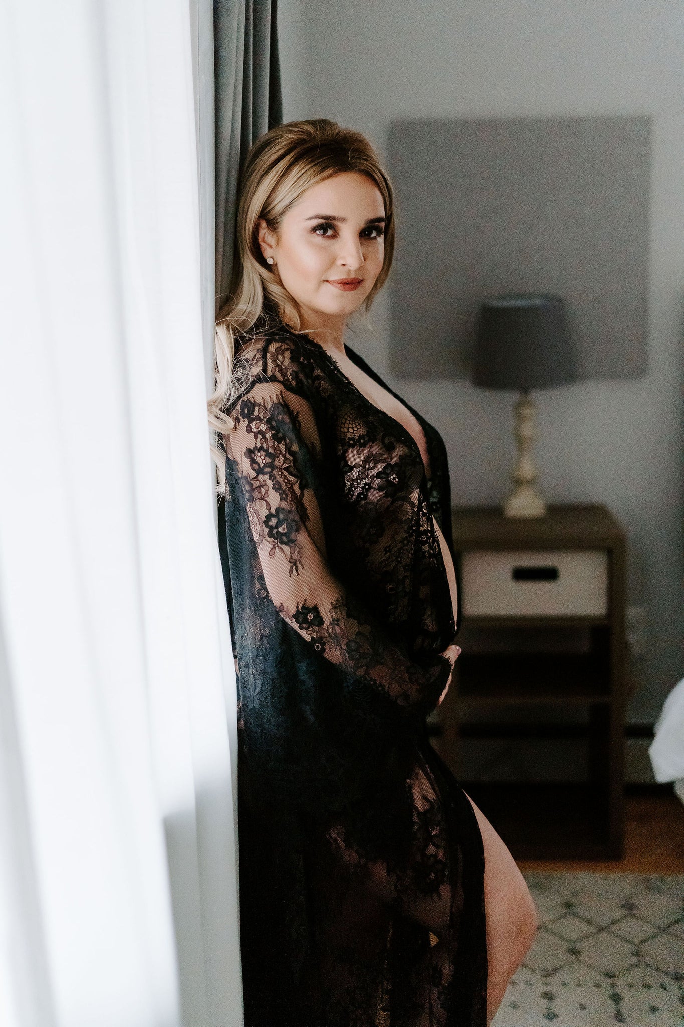 Pregnant model wearing black lace robe