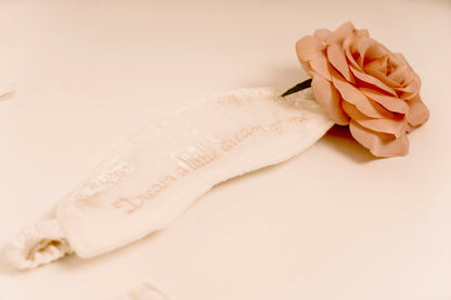 White sleeping mask with text